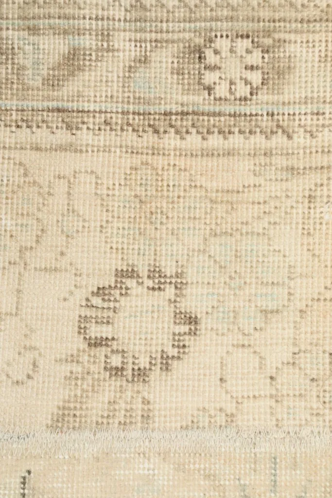 Close-up of the low wool pile and intricate hand-knotted details of the rug.