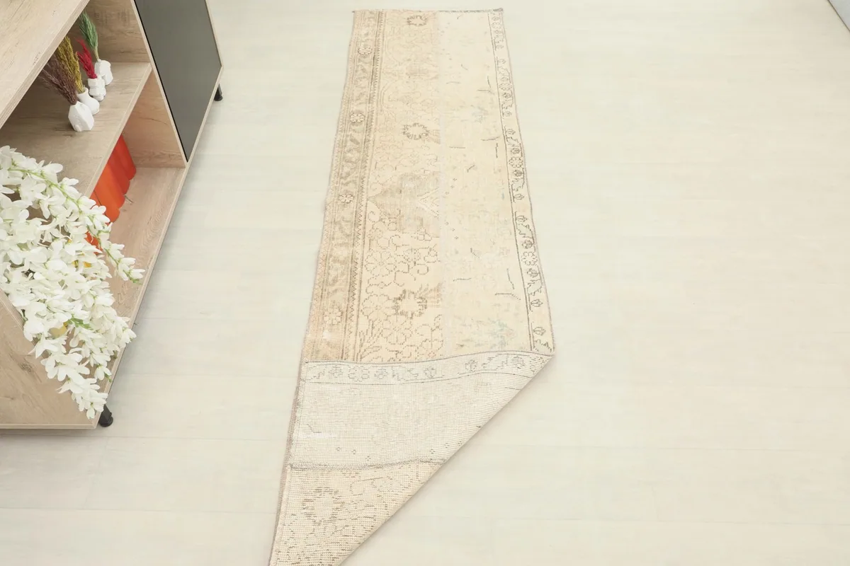 The runner rug partially folded, displaying its flexibility and construction.
