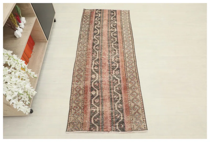 Full top view of the 2'2" x 5'7" rose, gray, and beige striped vintage runner