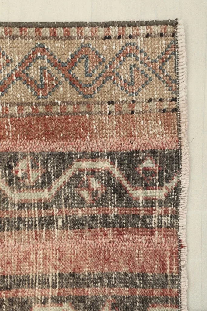 Close-up of the runner's edge and fringe, showing the weave and subtle wear