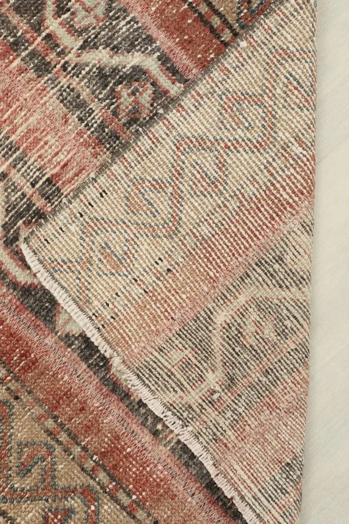 View of the rug's backside, showing the cotton foundation and hand-knotted construction