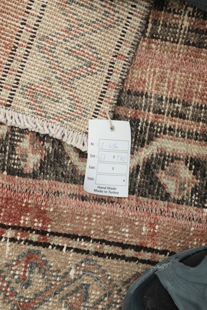 Close-up of the rug's tag, confirming its hand-made origin in Turkey