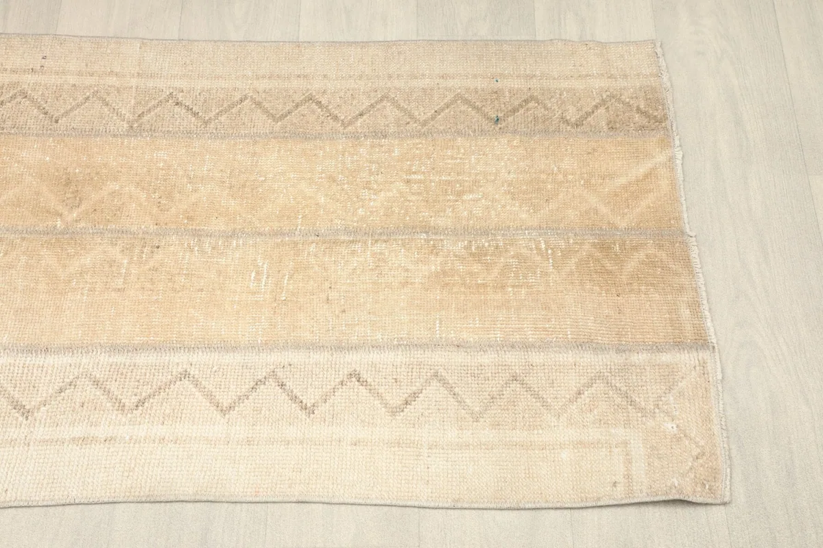 Another angled view of the rug, focusing on the end with the geometric stripes