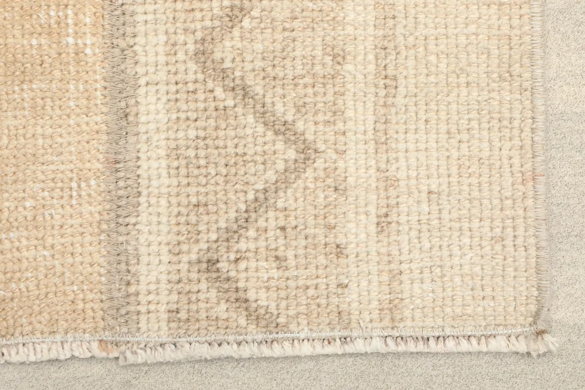 Close-up of the rug's edge, showing the low pile and subtle fringe