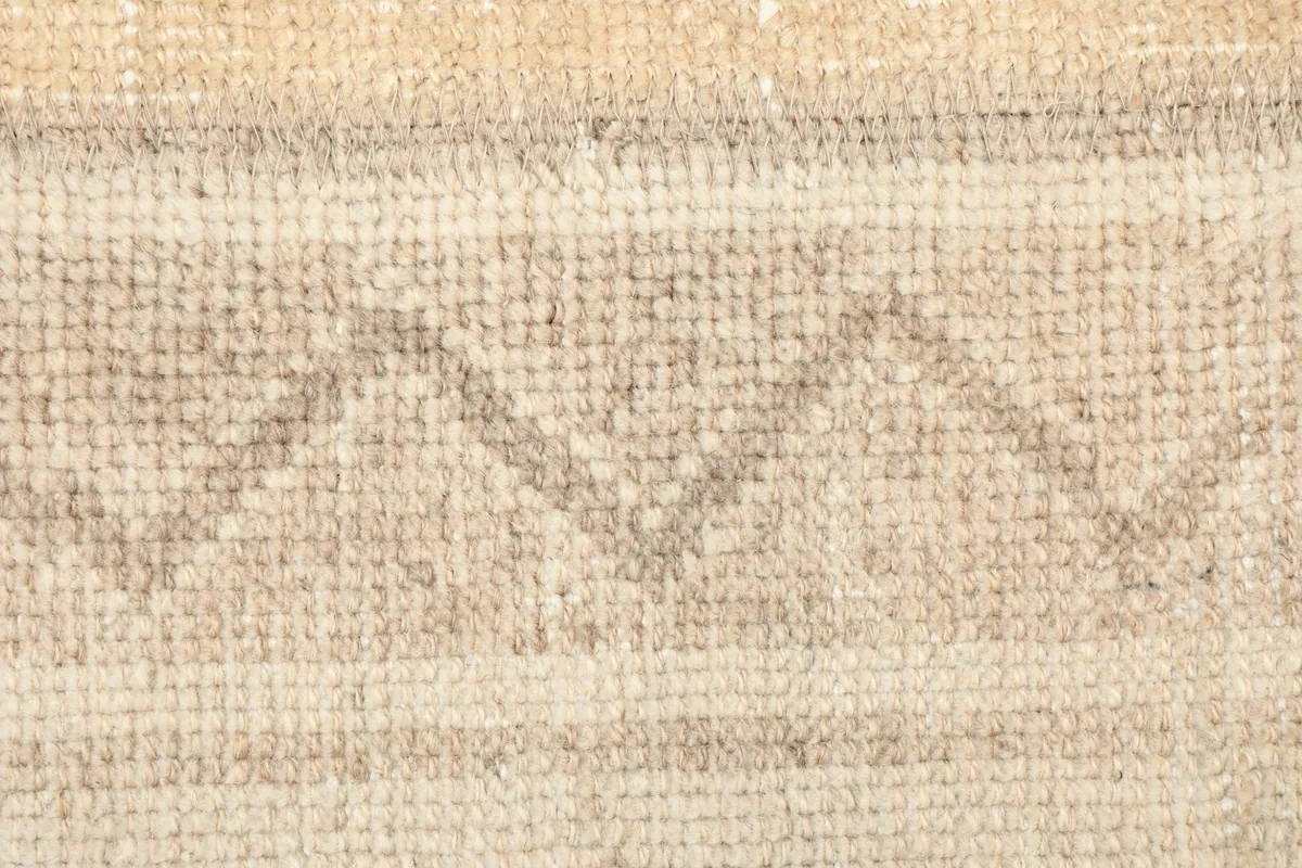 Detailed view of the zigzag geometric pattern within the striped design of the rug