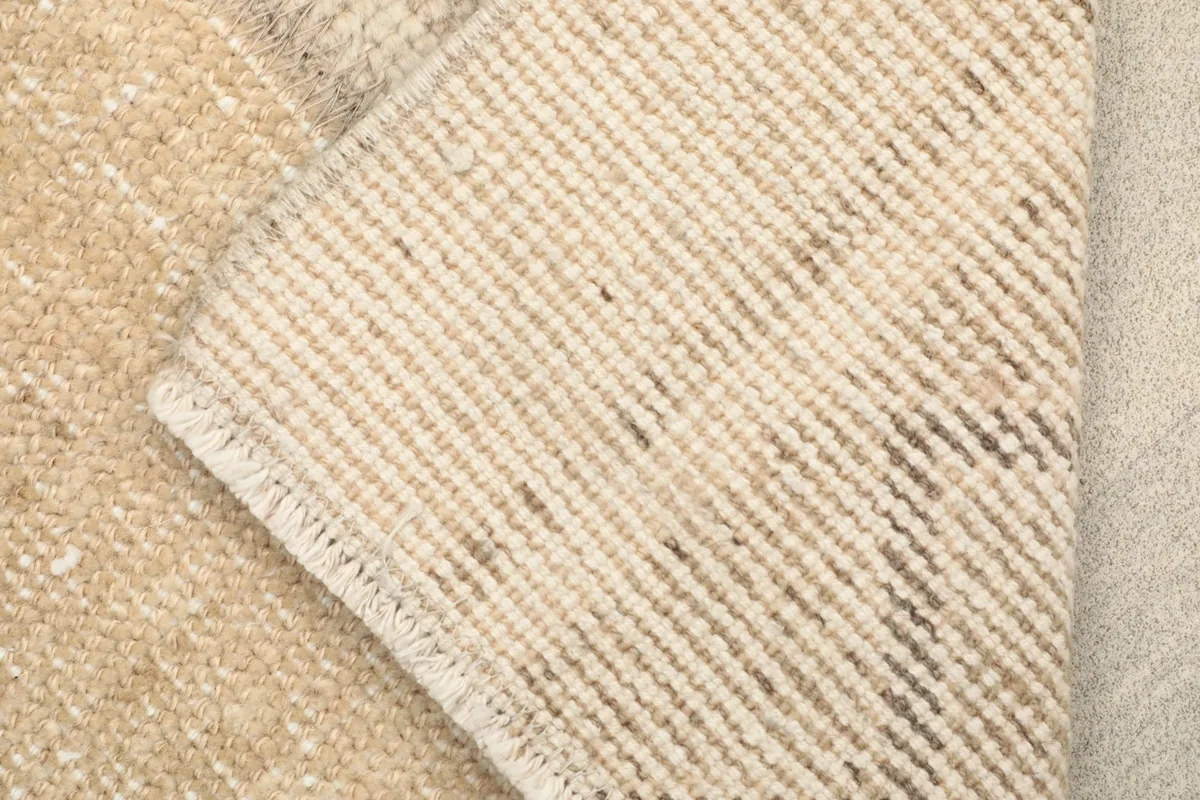 View of the rug's reverse side, showing the hand-knotted cotton foundation