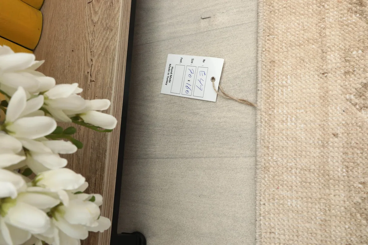 Close-up of the product tag attached to the vintage Anatolian rug