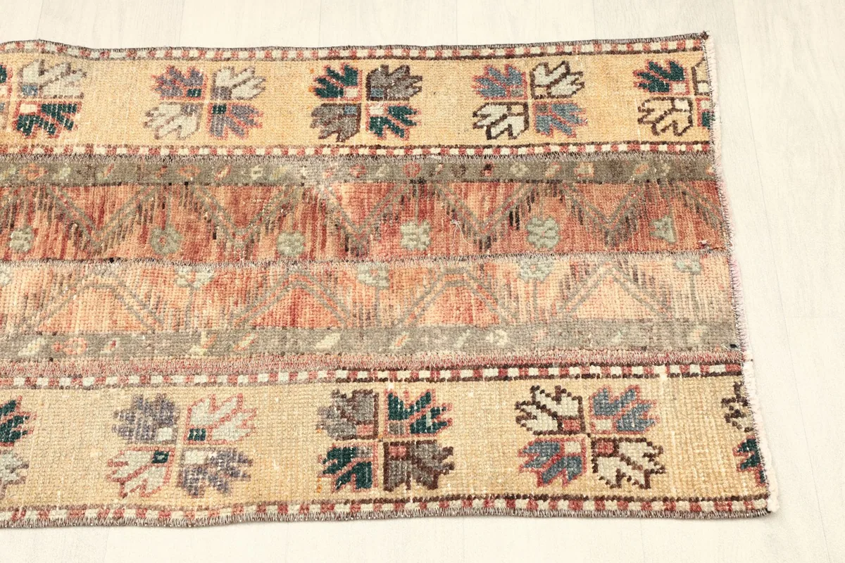 View of the opposite side of the rug, showing the consistent striped pattern and color variations.