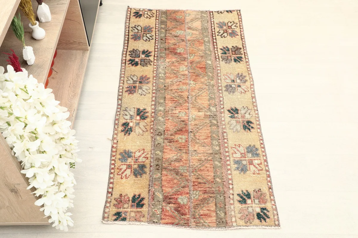 Full overhead view of the hand-knotted wool rug, showing its striped geometric pattern and colors.