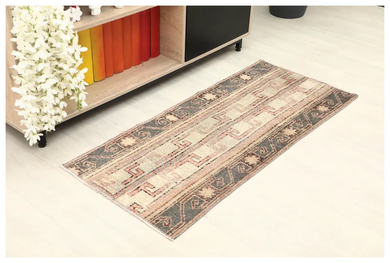 Full top view of the 2x4 vintage Anatolian rug with cream, rust, and gray geometric patterns