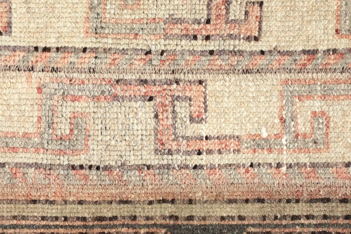 Macro detail of the central geometric pattern in cream and rust tones