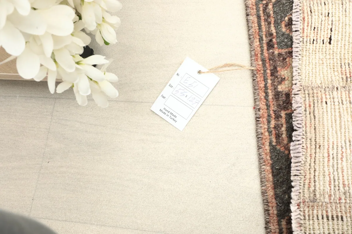 Partial view of the rug with a product tag, indicating its origin and quality