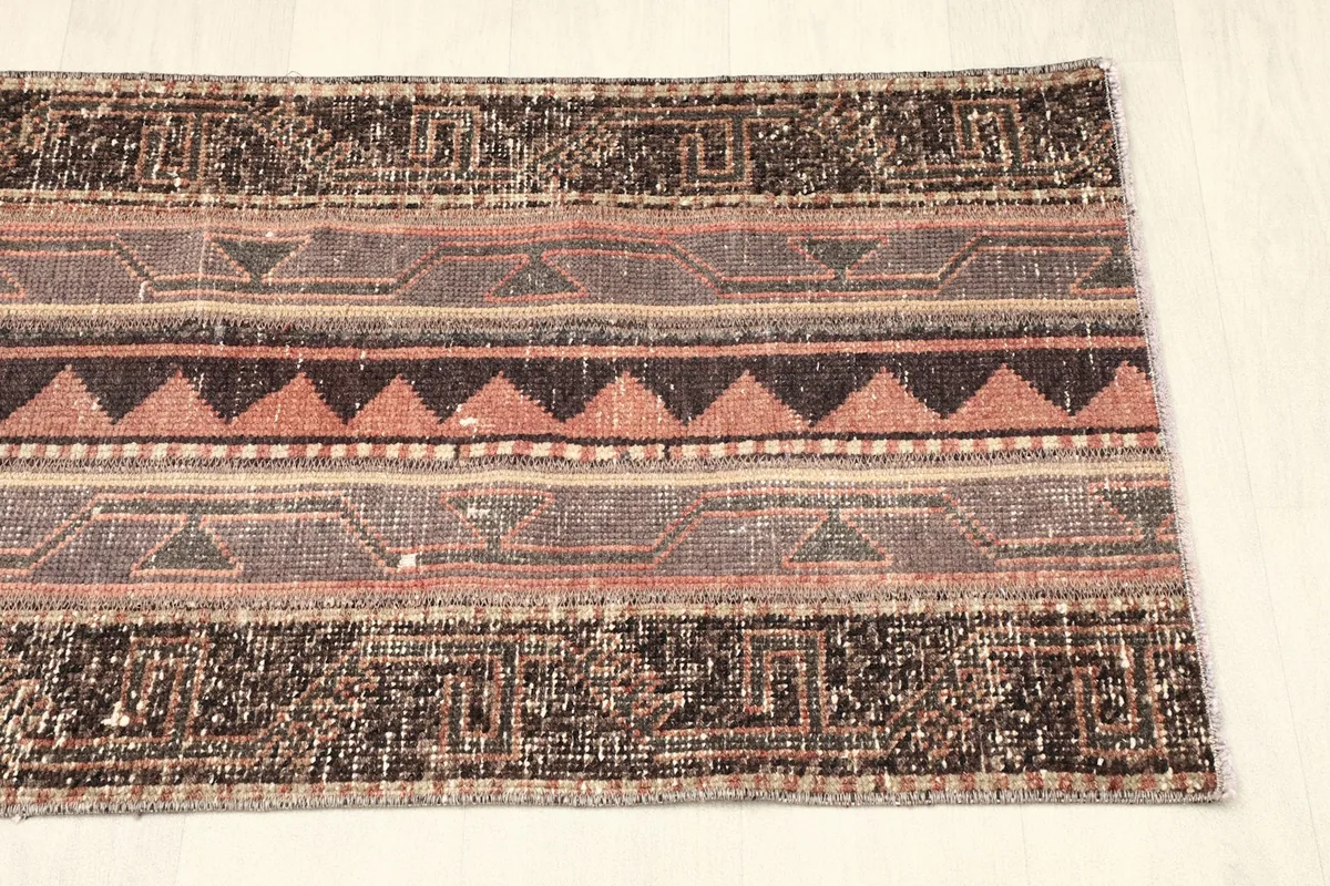 Partial view of the rug from the opposite end, showcasing the consistency of its design.
