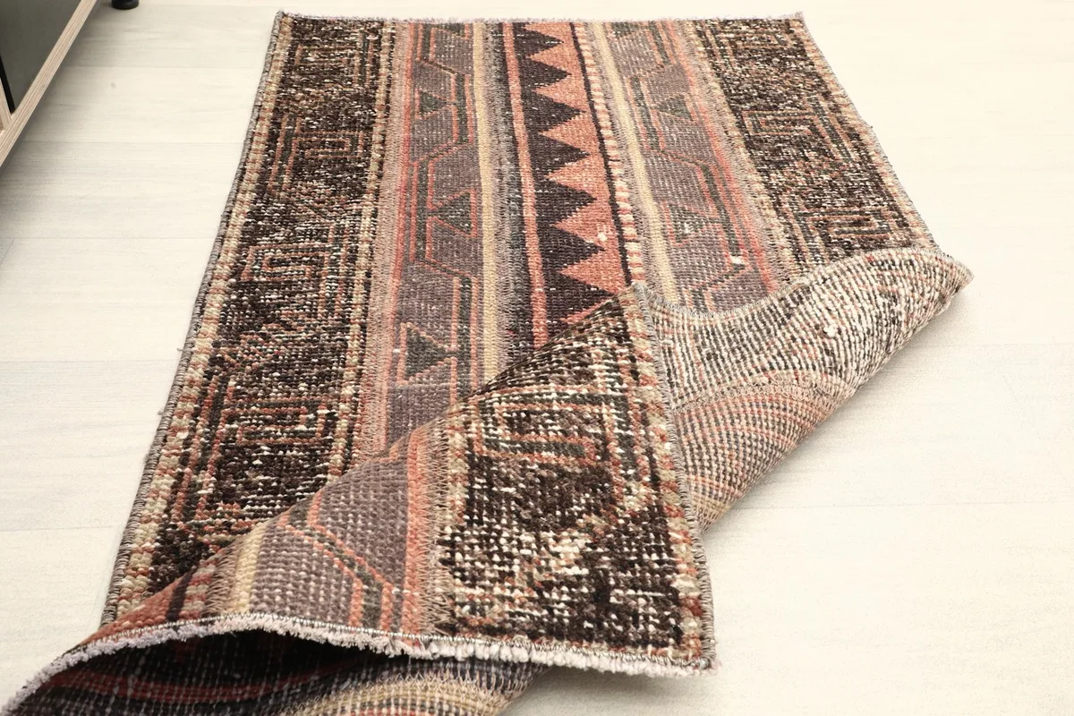 The rug folded to show both the front pile and the back foundation.
