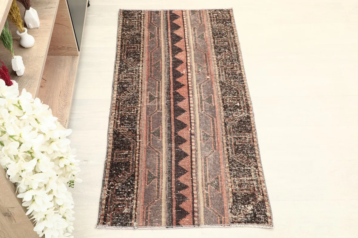 Direct overhead view of the vintage Anatolian rug, highlighting its striped geometric patterns.