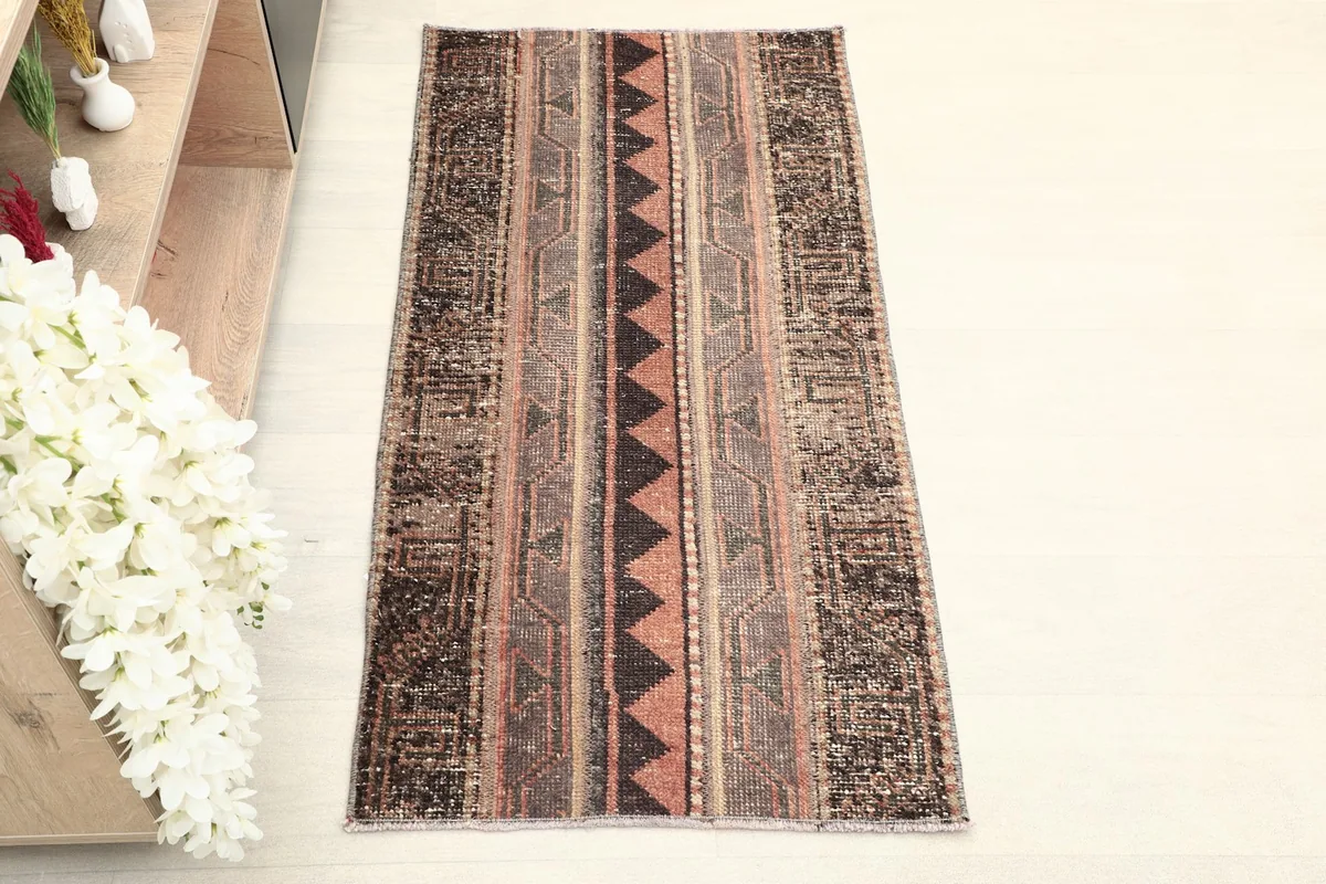 Overhead view of the vintage rug, showcasing its striped tribal patterns and colors.