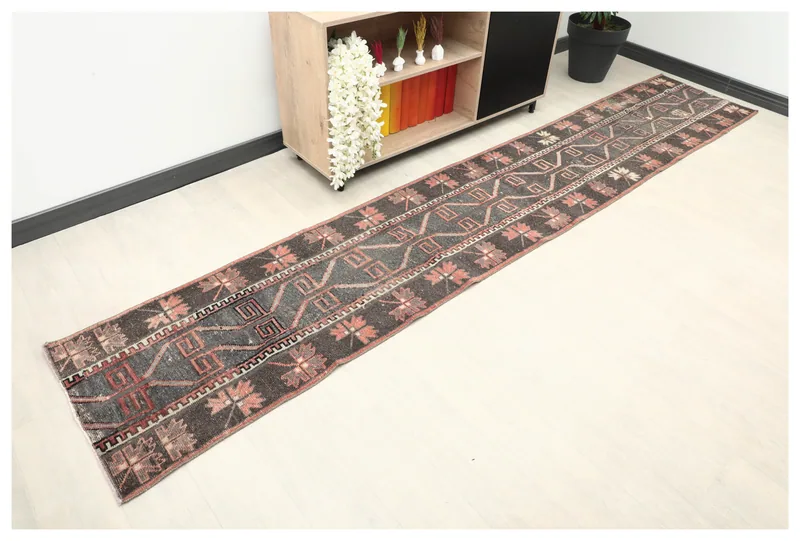 Full top view of the 2'2" x 11'10" charcoal and rust geometric vintage runner rug
