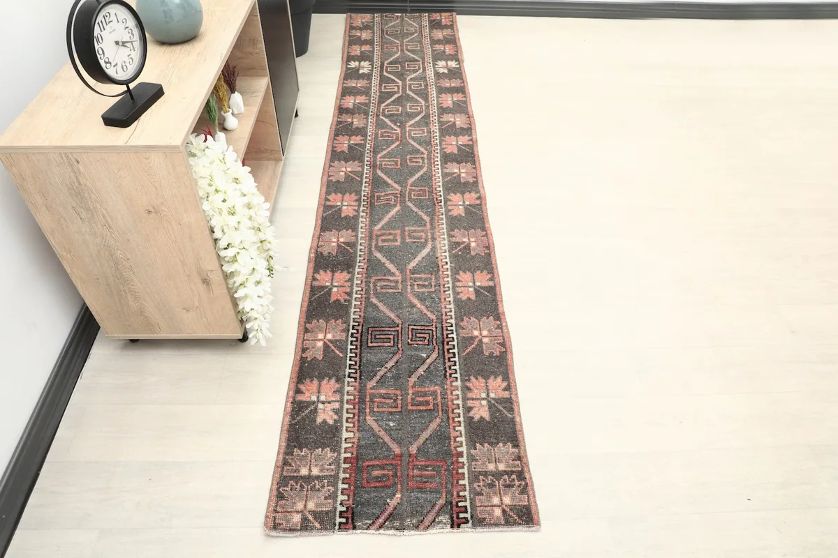 Runner rug placed in a hallway setting, demonstrating its long, narrow dimensions