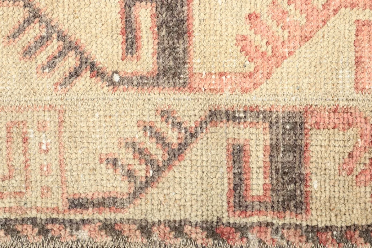 Tight detail shot of the hand-knotted wool pile and woven texture of the rug