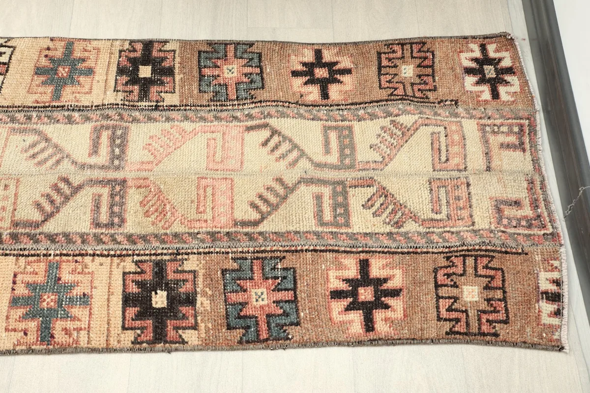 Mid-section overhead view showing the varied geometric patterns in beige, rust, black, and gray