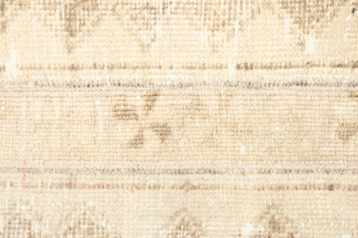 Detailed view of the repeating tribal geometric patterns and banded design on the rug's surface.