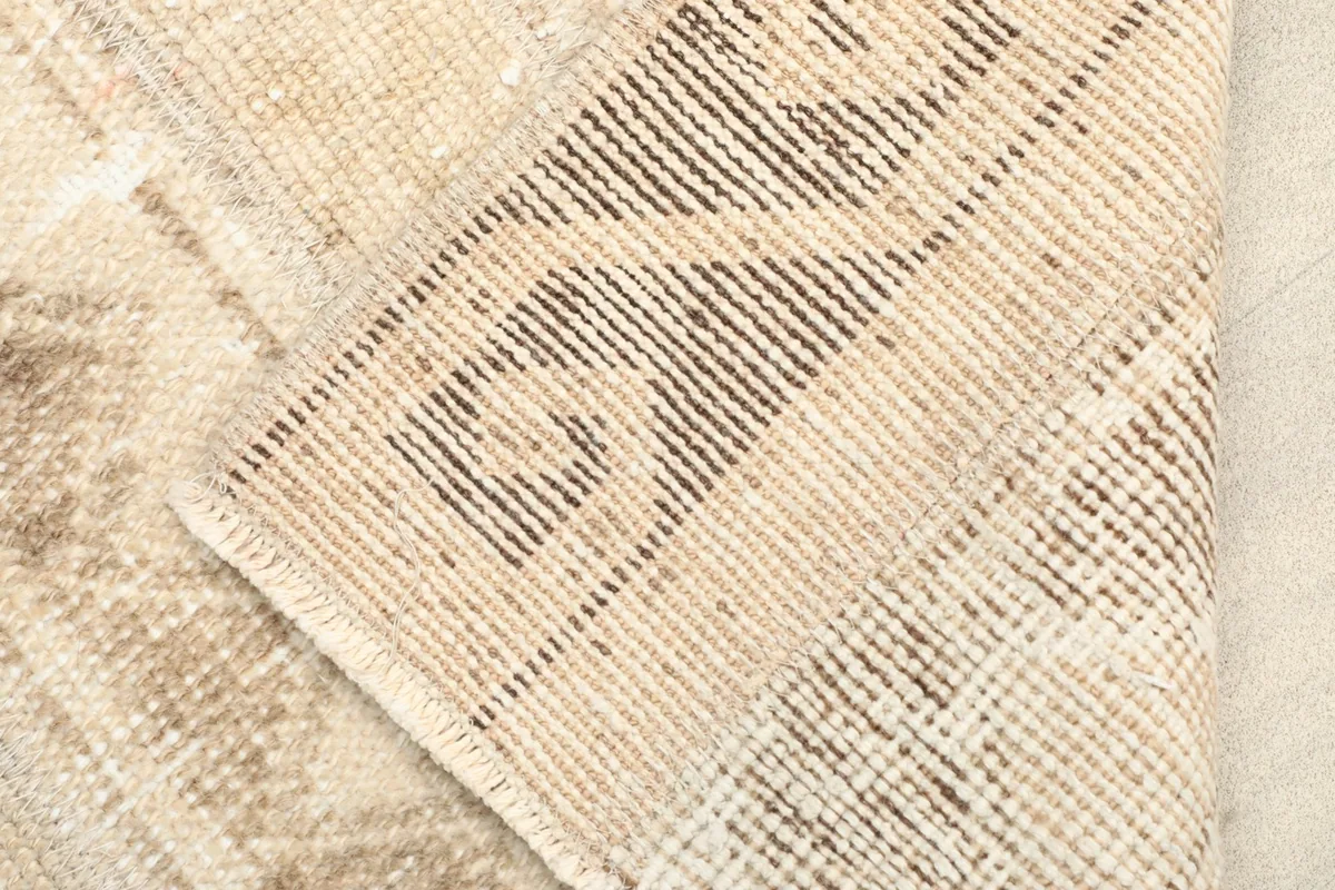 View of the rug's backside, revealing the hand-knotted cotton foundation and tight weave.