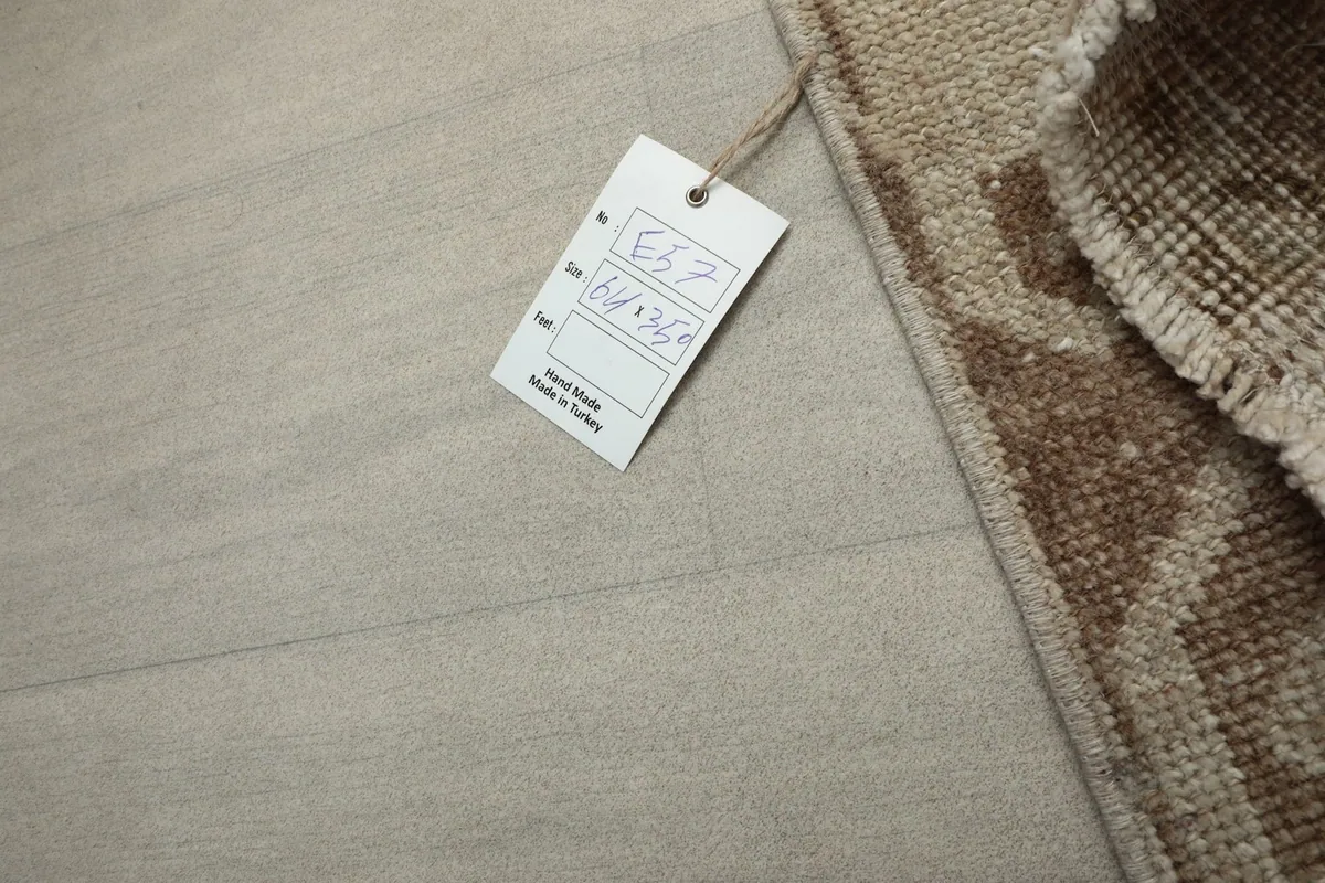 Close-up of the RugsKilim product tag, indicating 'Hand made in Turkey' and the rug's dimensions.