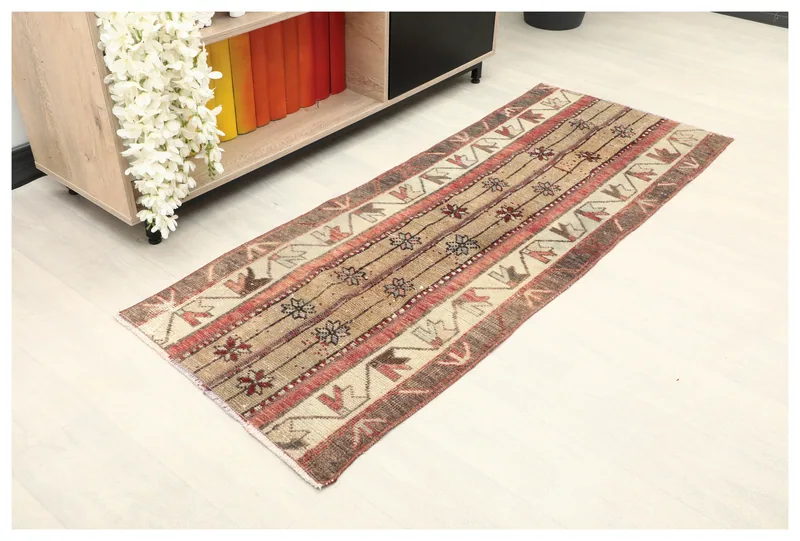 Full overhead view of the rustic tan geometric runner on a white background