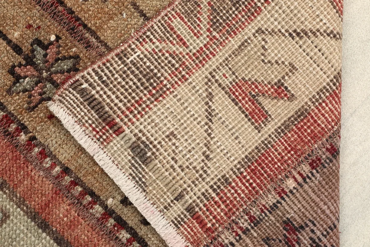 View of the back of the hand-knotted rug, revealing the cotton foundation and knotting