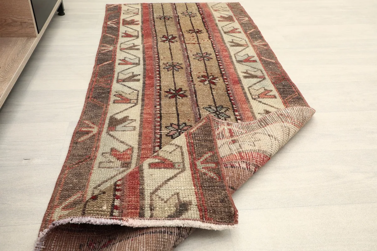 The runner partially folded, showing the flexibility and texture of the vintage wool