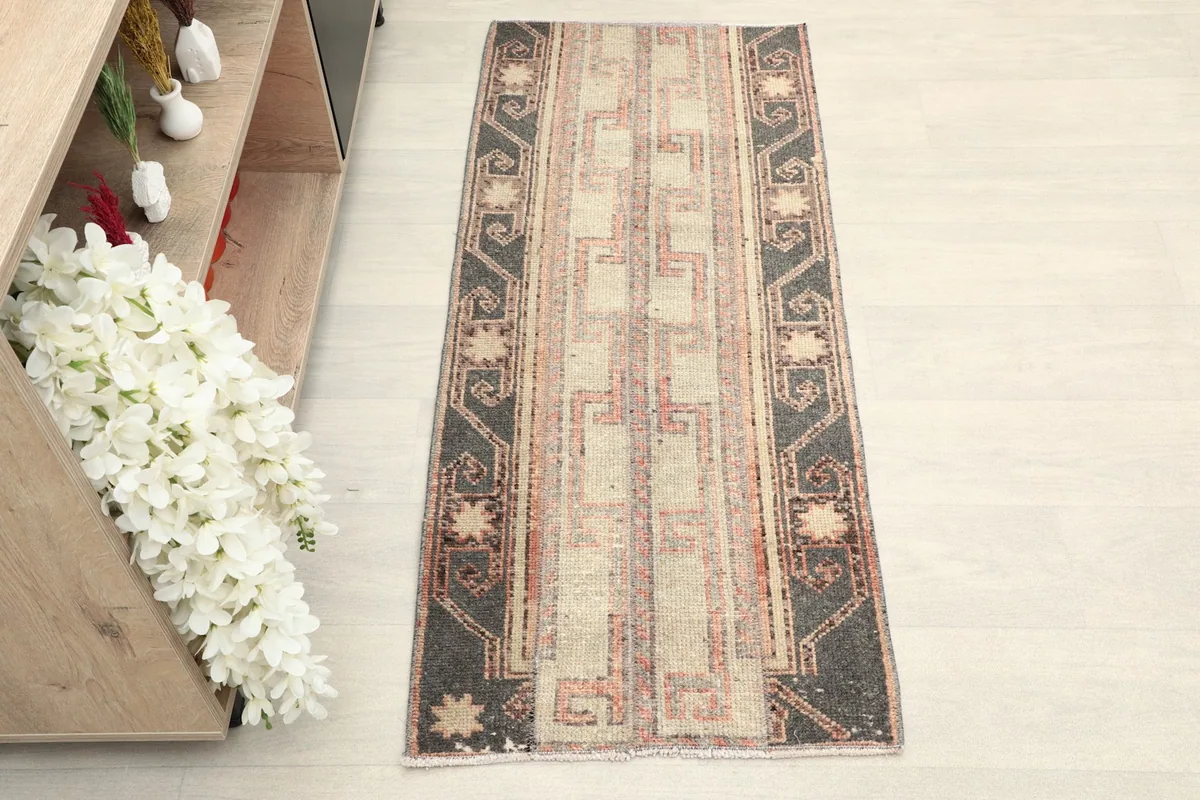 Overhead view of the vintage Anatolian rug, highlighting its geometric patterns and color variations.