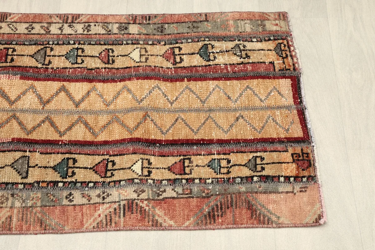 Angled shot of the rug's right side, revealing the full pattern repeat and color variations.