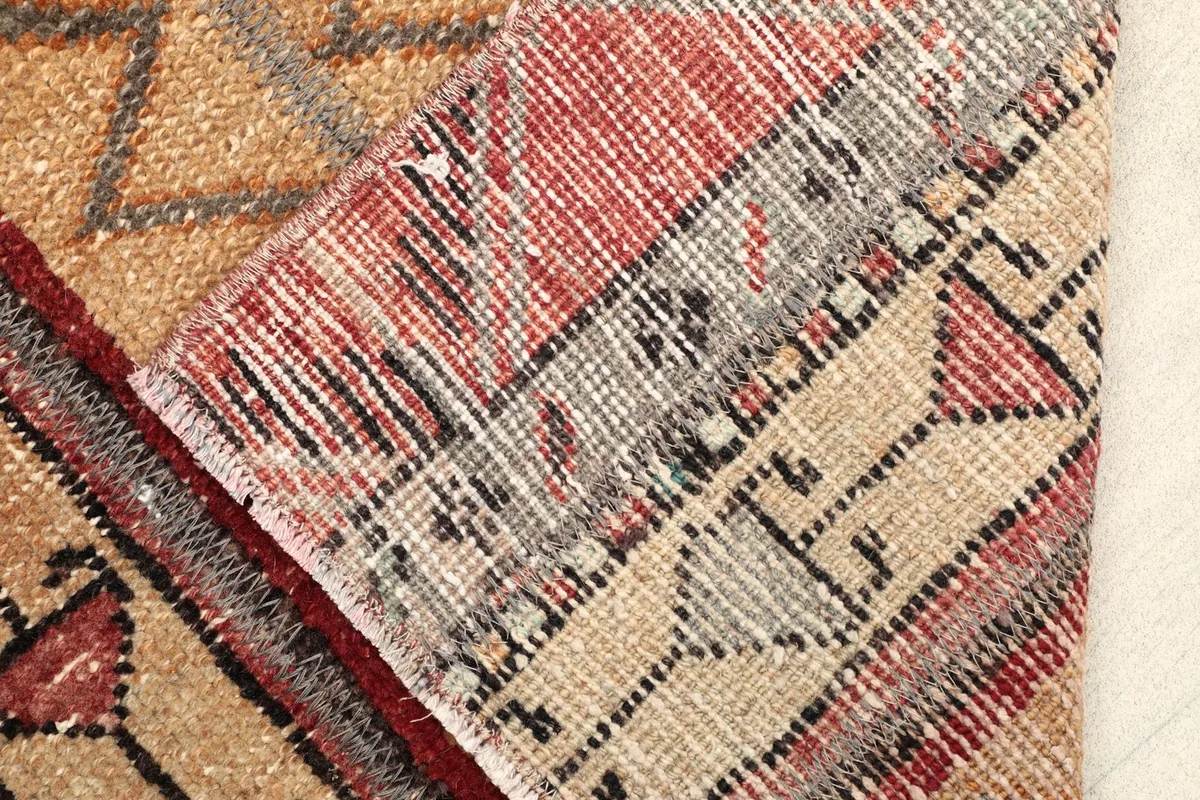 Detail of the rug's backside, showing the hand-knotted construction and cotton foundation.
