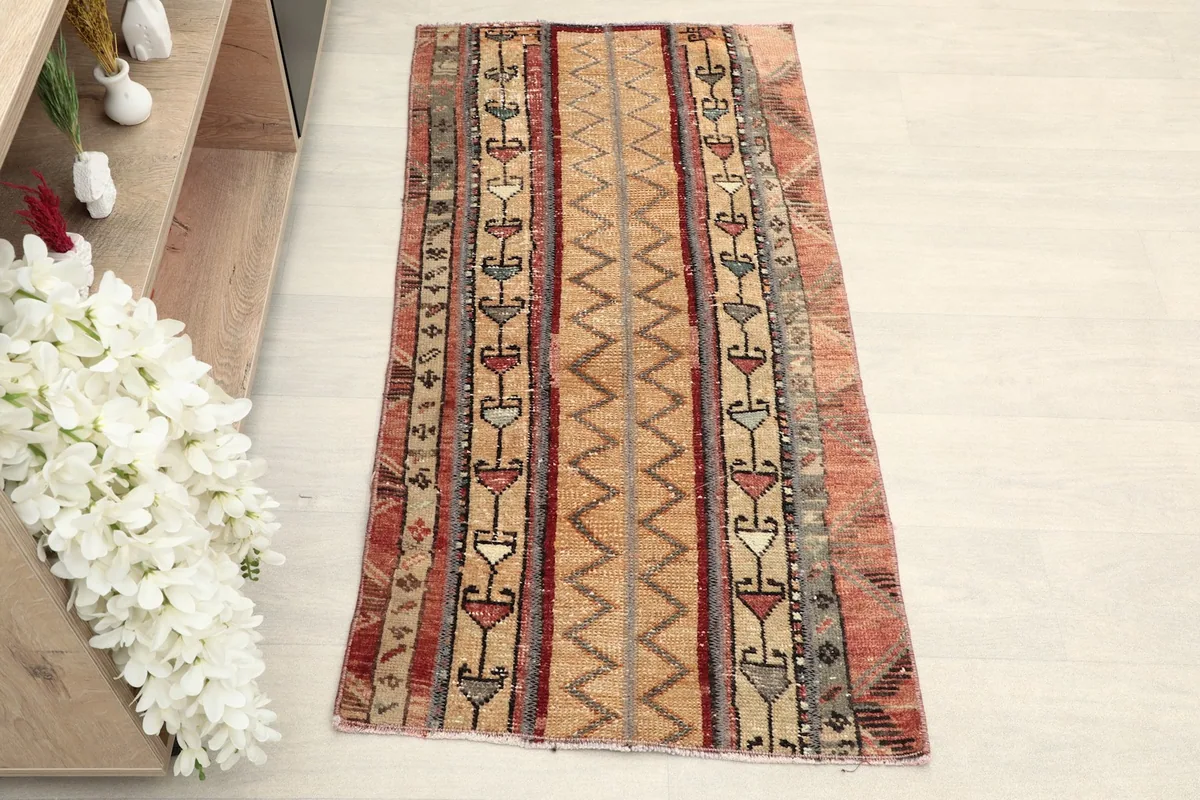 Overhead view of the vintage Anatolian rug, highlighting its full length and striped pattern.
