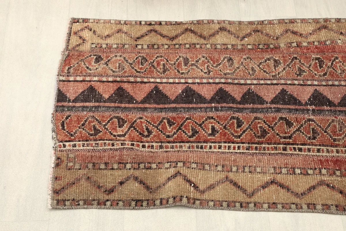Angled shot of one end of the runner, showing the distinct striped and geometric sections.