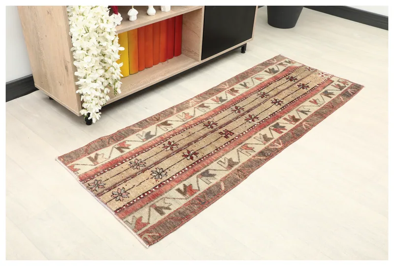 Full top view of the 2'1" x 5'7" vintage Anatolian runner rug with tan, red, and brown tribal patterns.