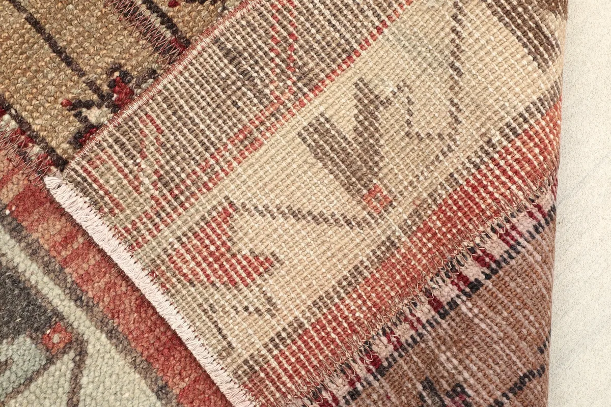 Close-up of the back of the hand-knotted rug, revealing the cotton foundation and knot structure.