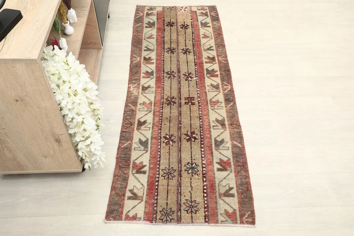 Overhead view of the hand-knotted wool runner, highlighting its full length and tribal geometric design.