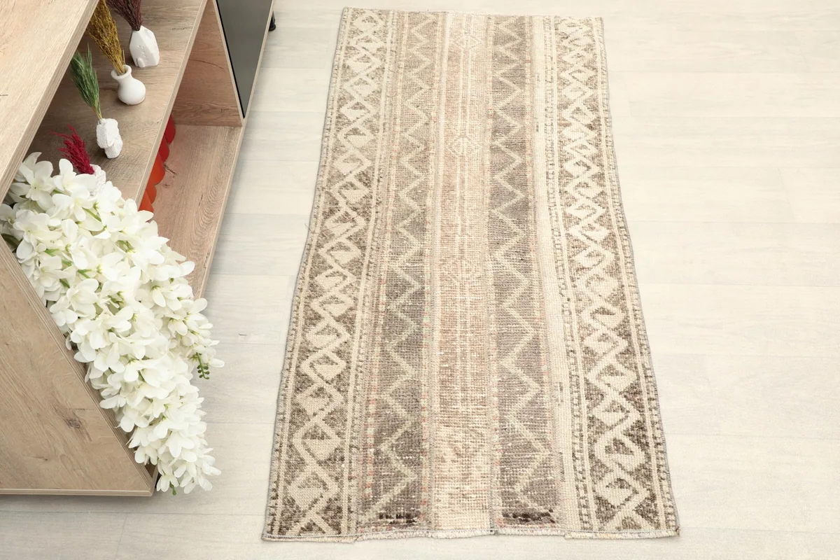 Overhead view of the hand-knotted wool rug, showing its full length and striped tribal design
