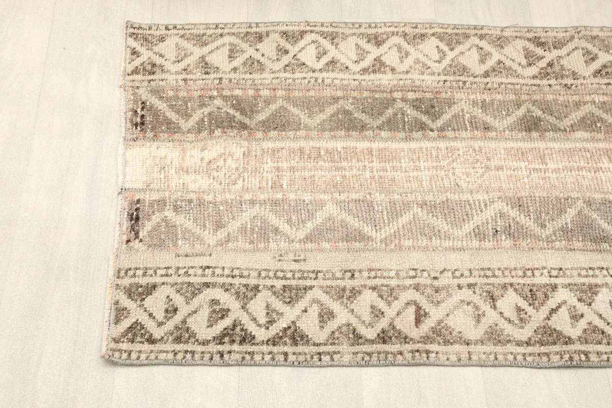 Overhead view of one end of the rug, displaying the distinct banded and zigzag tribal motifs