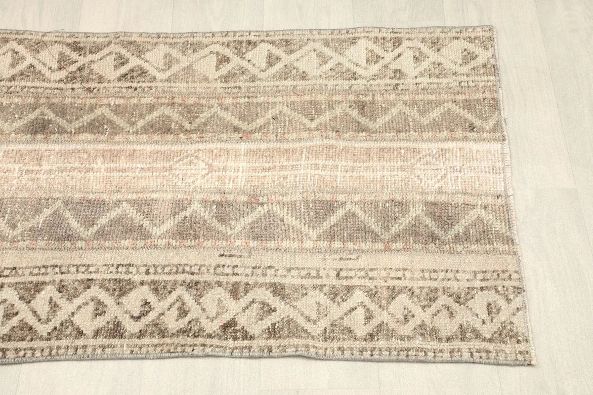 Overhead view of the other end of the rug, showing consistent geometric patterns and color palette