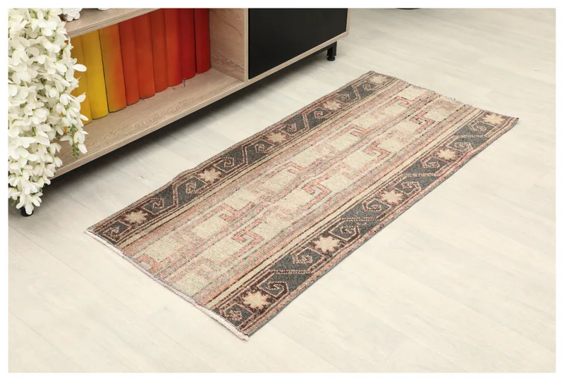 Full top view of the 1'10" x 4'0" beige and charcoal geometric vintage Anatolian rug on a white background.