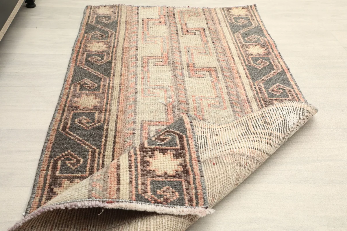 The rug partially folded, demonstrating its pliable nature and craftsmanship.