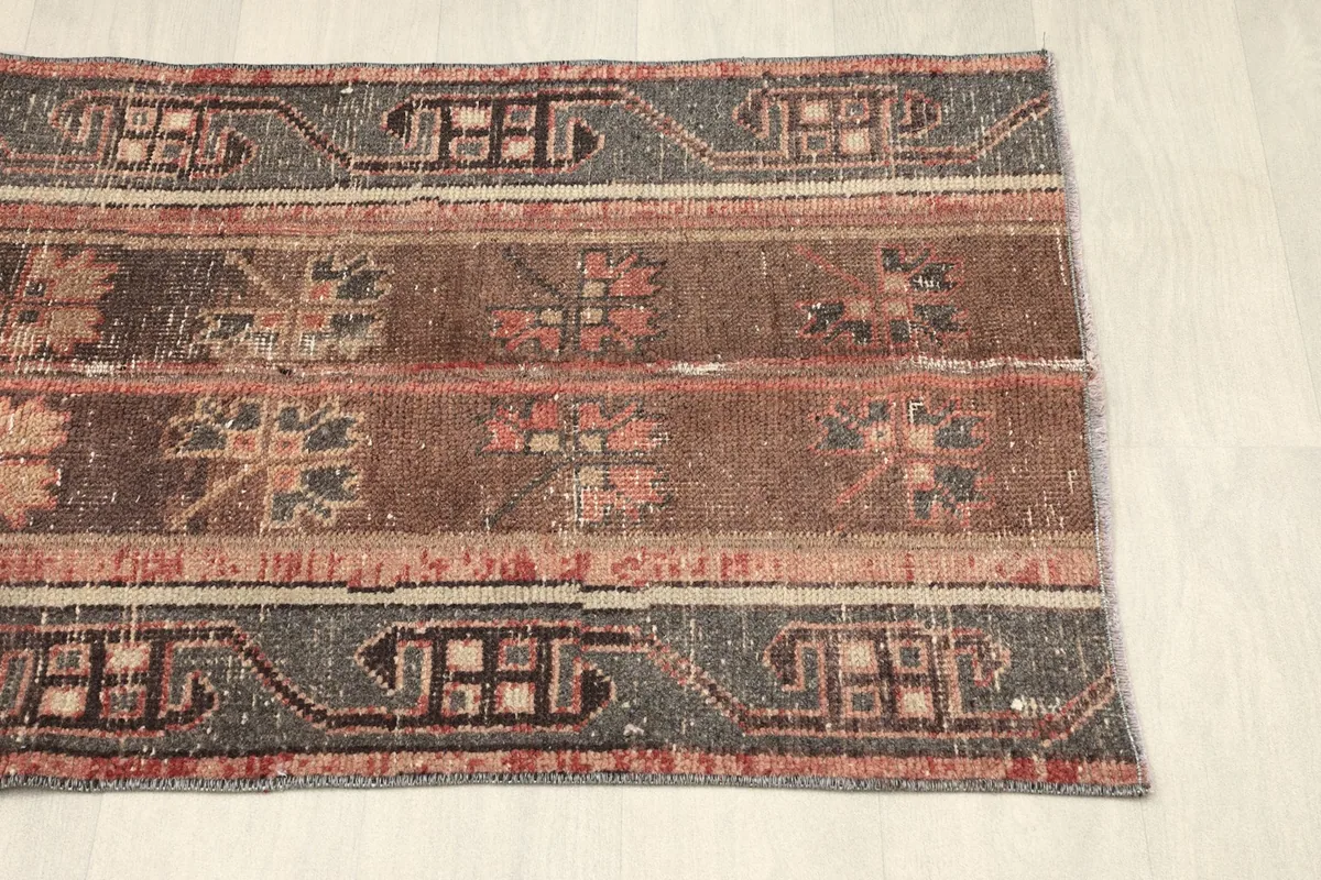 Opposite side view of the rug, showing the consistent striped pattern and border details.
