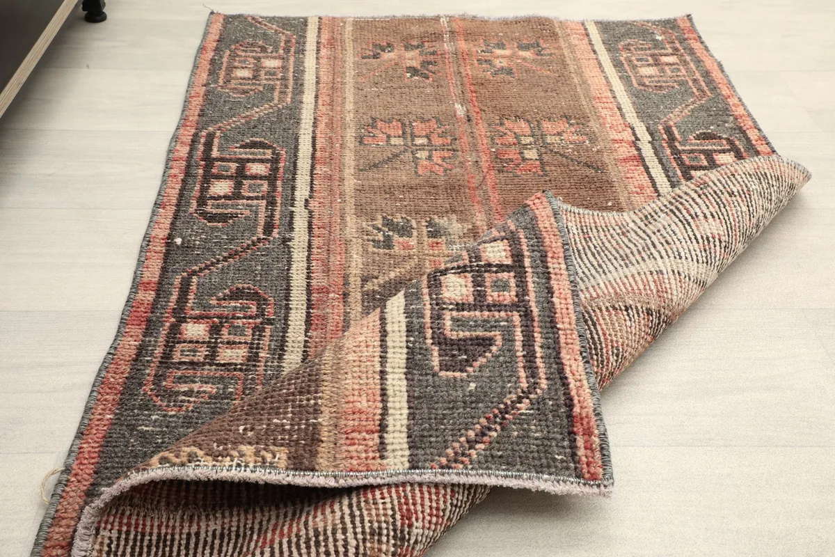 The rug folded to reveal both the pile and the foundation, demonstrating its flexibility.