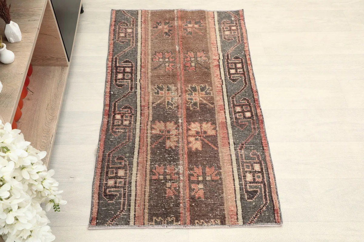Overhead view of the hand-knotted wool rug, highlighting its striped pattern and tribal motifs.