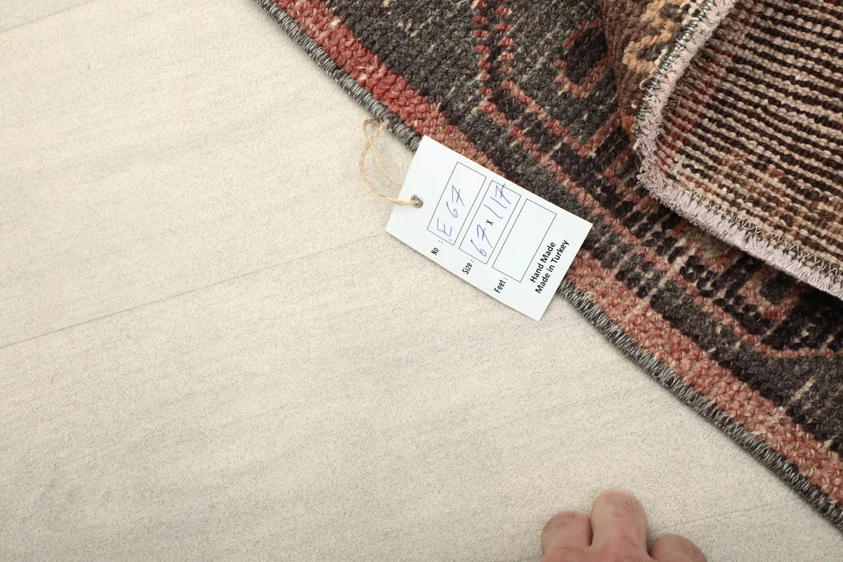 A small tag on the rug, indicating its origin and unique details.