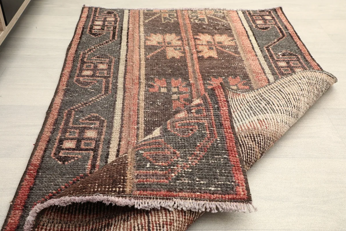 The rug partially folded, demonstrating its flexibility and construction.