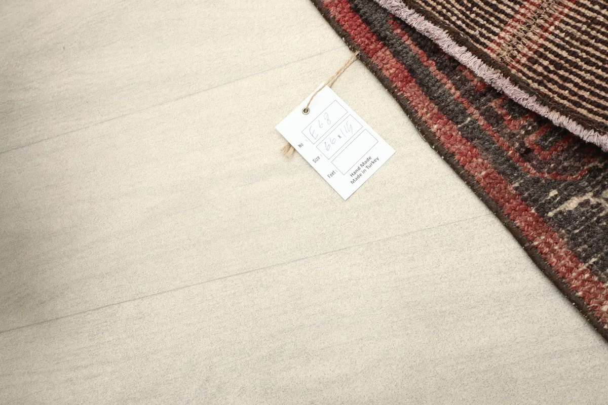 Close-up of the rug's corner with the product tag, indicating its origin and material.