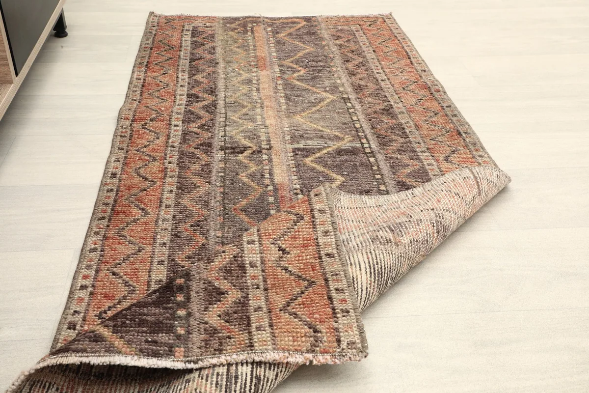 The runner partially folded, illustrating its flexibility and the character of its vintage wool.